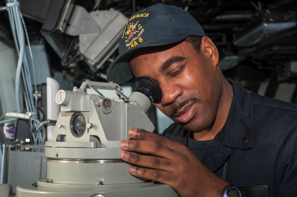 USS AMerica Sailor records ship's bearing