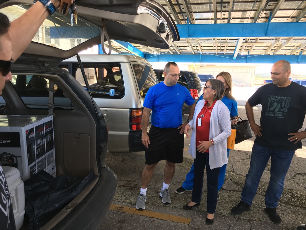 Local resident receives a generator as a gift from Coast Guard members during Hurricane Maria response