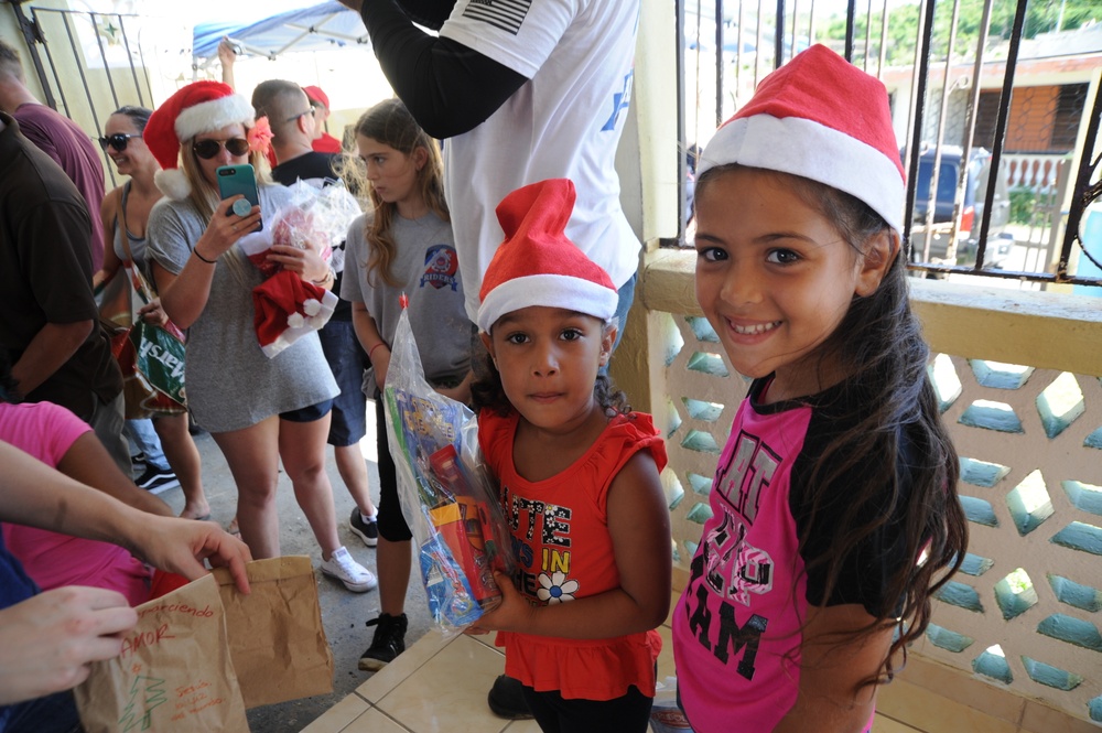 Coast Guardsmen deliver toys to children in Naguabo, Puerto Rico