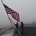 Sailors prepare to lower flag