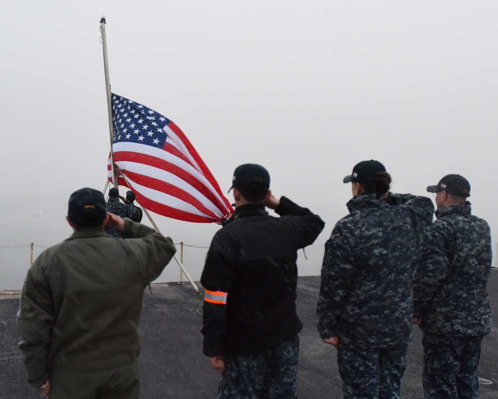 Sailors lower flag