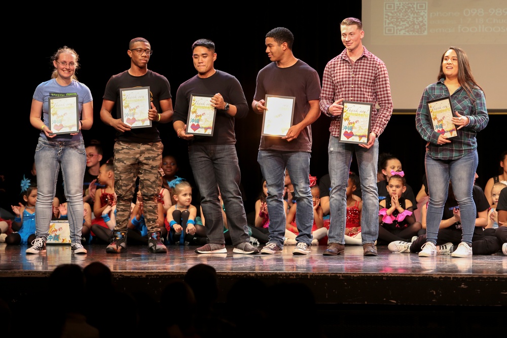 Marines volunteer with dancers at FootLoose Winter Showcase