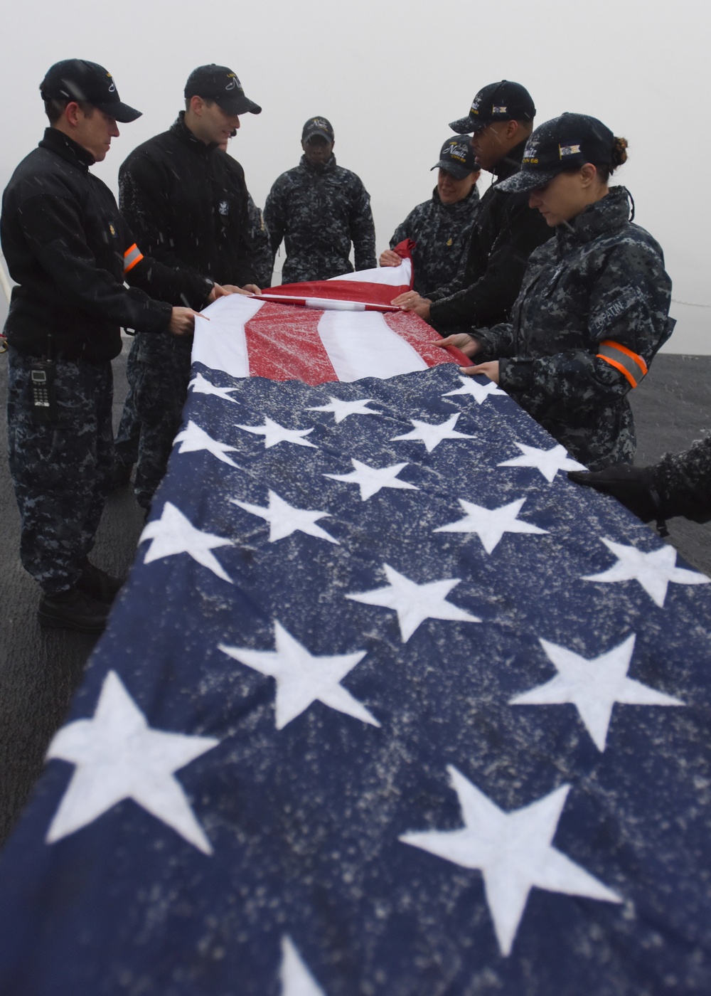 Sailors fold flag