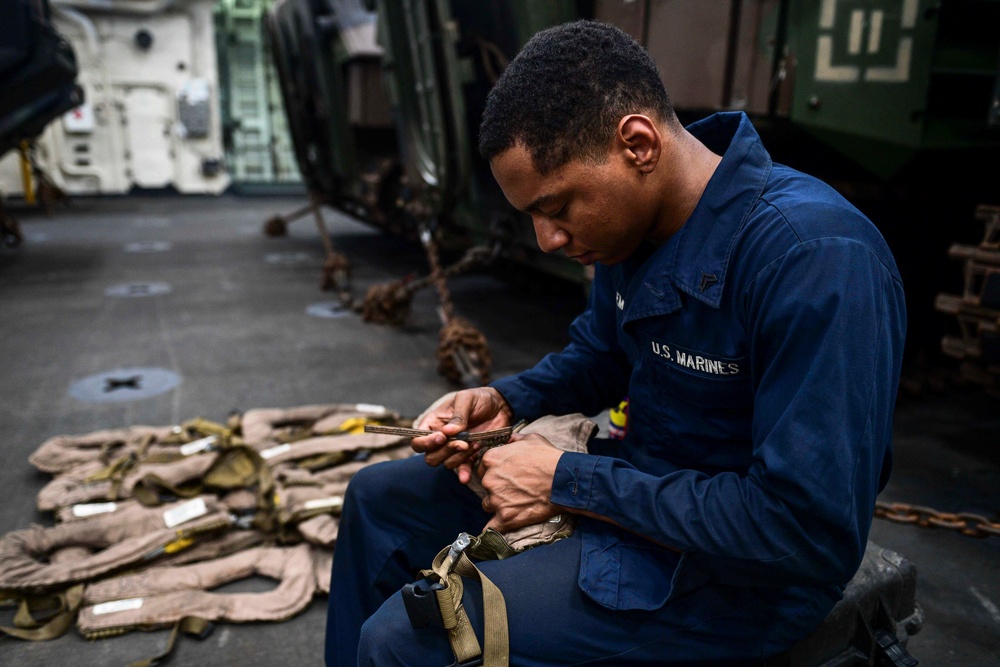 USS San Diego (LPD 22) Embarked Marine Cleans Life Preservers