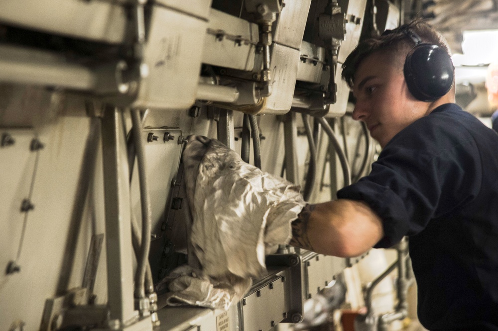 USS San Diego (LPD 22) Fireman Cleans An Engine
