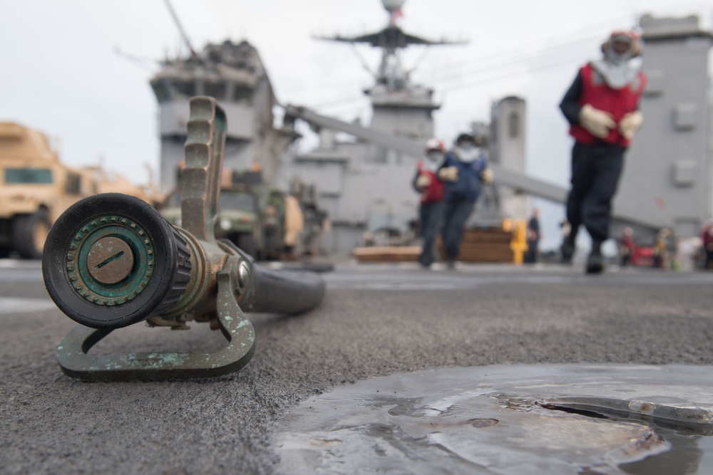 USS Pearl Harbor Sailors participate in a flight deck firefighting drill