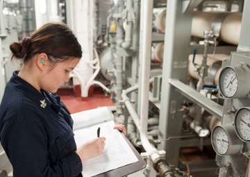 USS America (LHA 6) Sailor takes readings while on watch