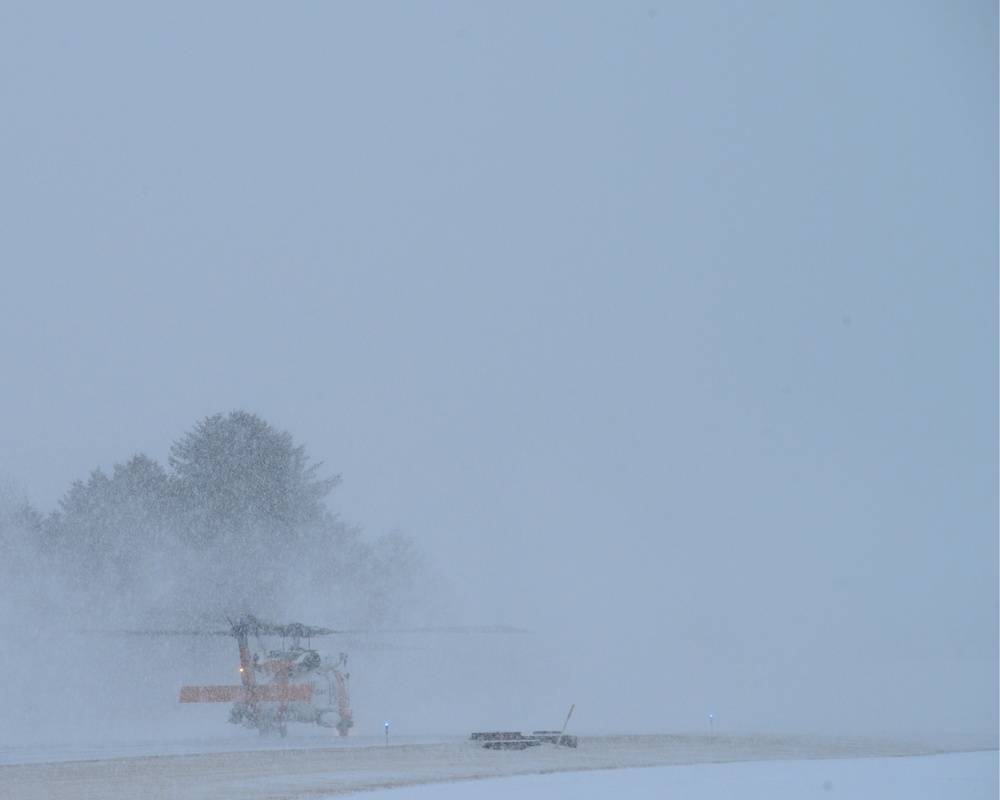 Air Station Kodiak MH-60 Jayhawk helicopter crew taxis during snowstorm