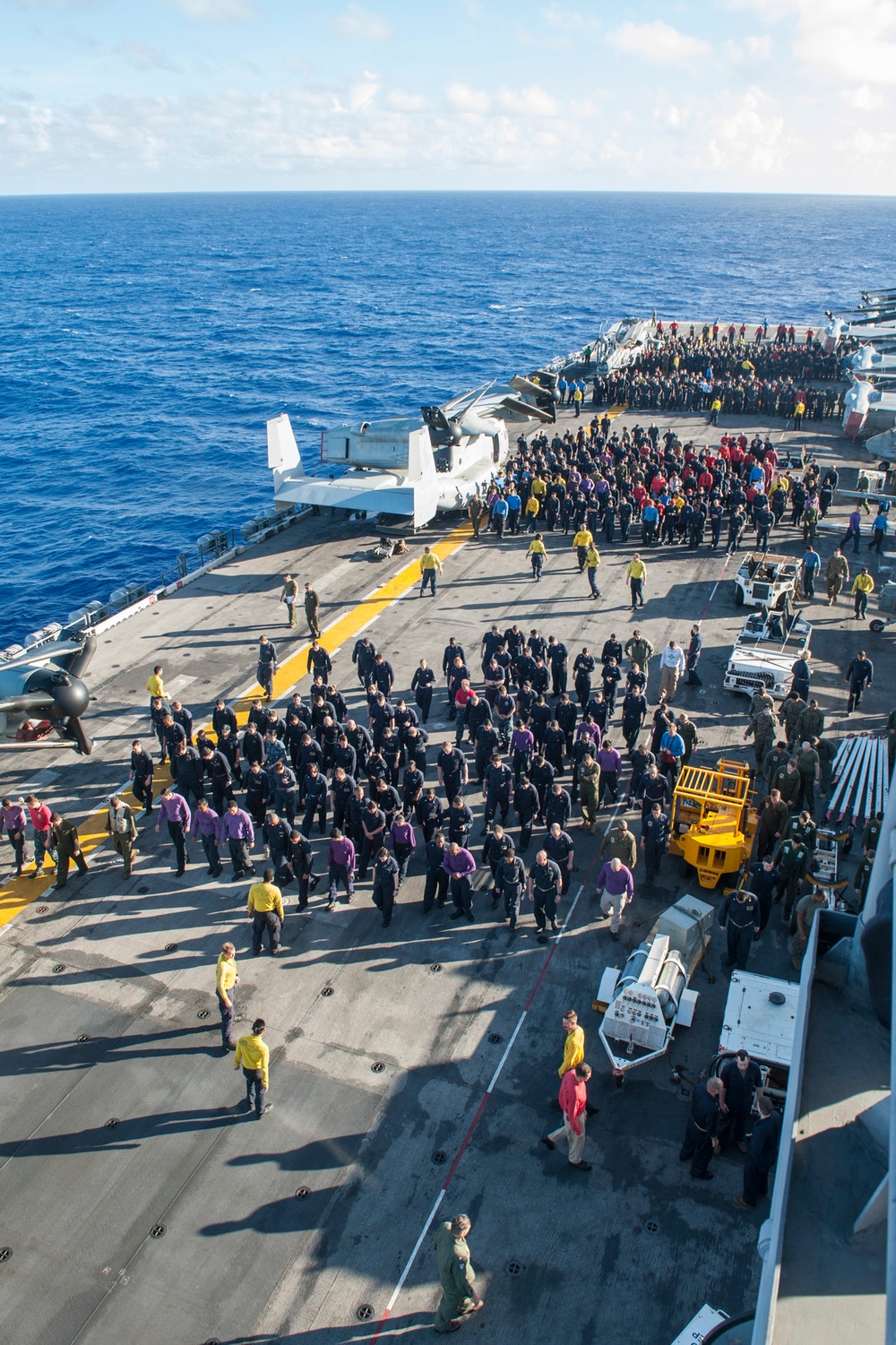 USS Sailors and Marines inspect flight deck for debris