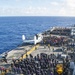 USS Sailors and Marines inspect flight deck for debris
