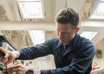 USS America (LHA 6) Sailor tests electrical equipment in the calibration lab