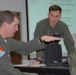 Maj. Jaquish explains mountain flying to visiting Marine Corps Pilots