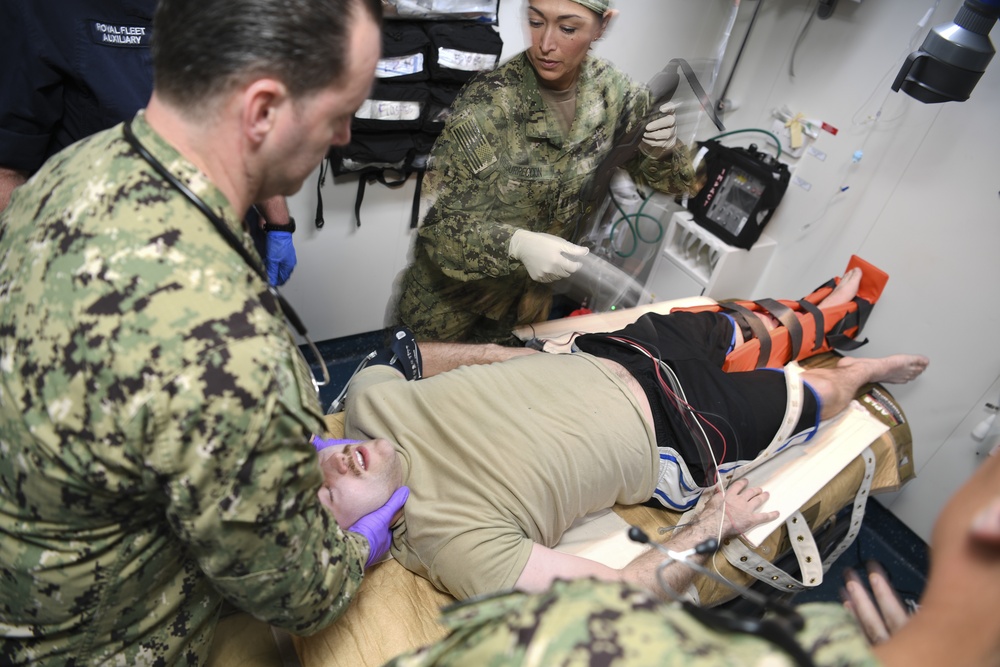 U.S. Navy and U.K. Royal Navy Sailors perform training on a Neil Robertson stretcher aboard Royal Fleet Auxiliary ship Cardigan Bay during exercise Azraq Serpent 18.