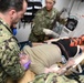 U.S. Navy and U.K. Royal Navy Sailors perform training on a Neil Robertson stretcher aboard Royal Fleet Auxiliary ship Cardigan Bay during exercise Azraq Serpent 18.