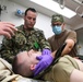 U.S. Navy and U.K. Royal Navy Sailors perform training on a Neil Robertson stretcher aboard Royal Fleet Auxiliary ship Cardigan Bay during exercise Azraq Serpent 18.