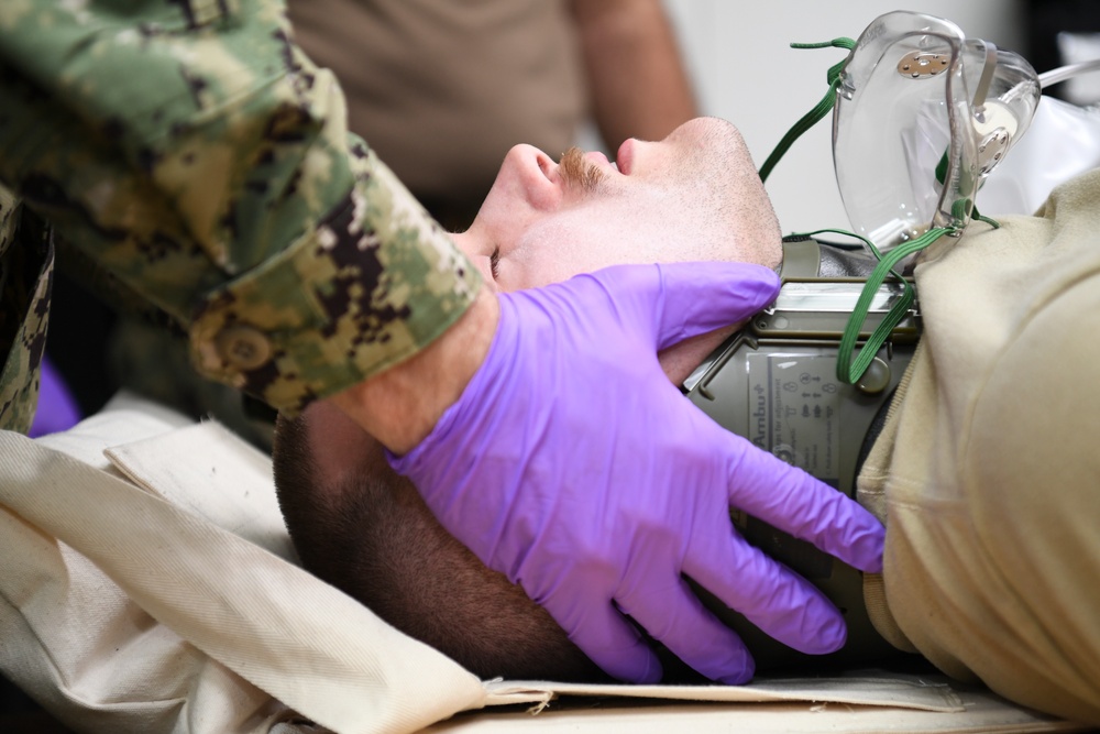 U.S. Navy and U.K. Royal Navy Sailors perform training on a Neil Robertson stretcher aboard Royal Fleet Auxiliary ship Cardigan Bay during exercise Azraq Serpent 18.