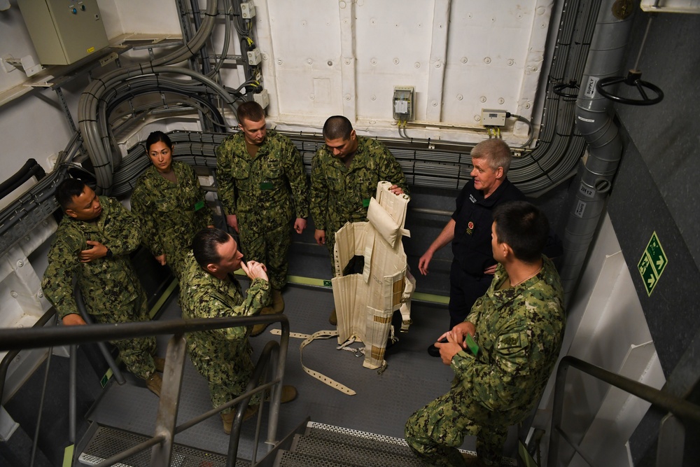 U.S. Navy and U.K. Royal Navy Sailors perform training on a Neil Robertson stretcher aboard Royal Fleet Auxiliary ship Cardigan Bay during exercise Azraq Serpent 18.