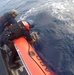 Coast Guard boat crew pulls bales of cocaine from the water