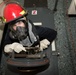 Sailor climbs through a scuttle during general quarters