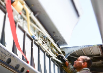 Airmen conduct maintenance on a KC-135 tanker