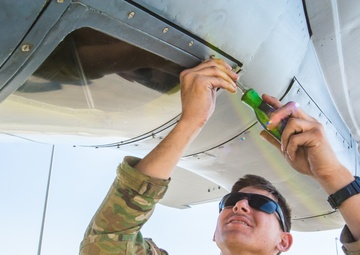 Airmen conduct maintenance on a KC-135 tanker