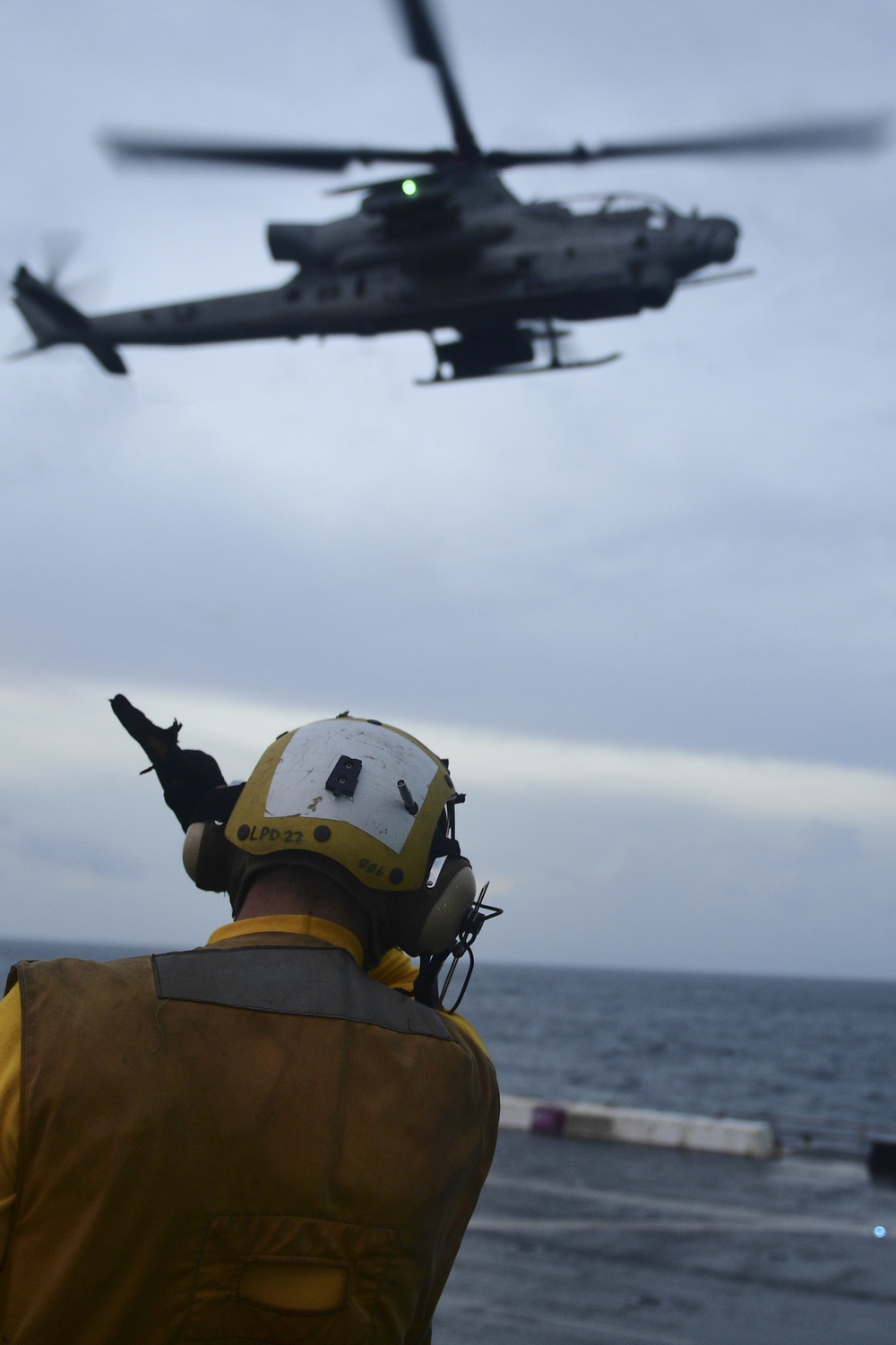 USS San Diego (LPD 22) Airman Directs AH-1Z Viper Attack Helicopter