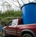 Survivors FIll Water Tanks On the Side of the Road