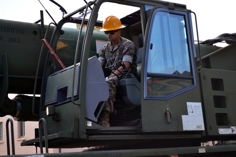 Marine heavy equipment operators move Army memorial