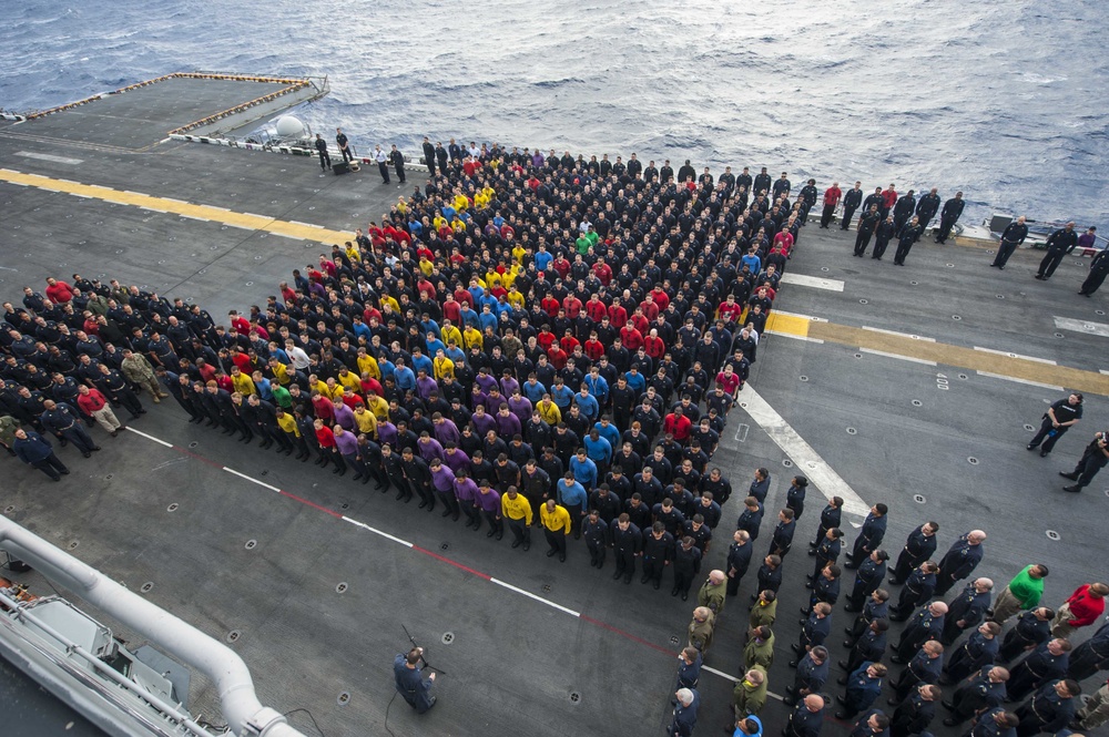 USS America (LHA 6) Sailors stand in formation for all-hands call