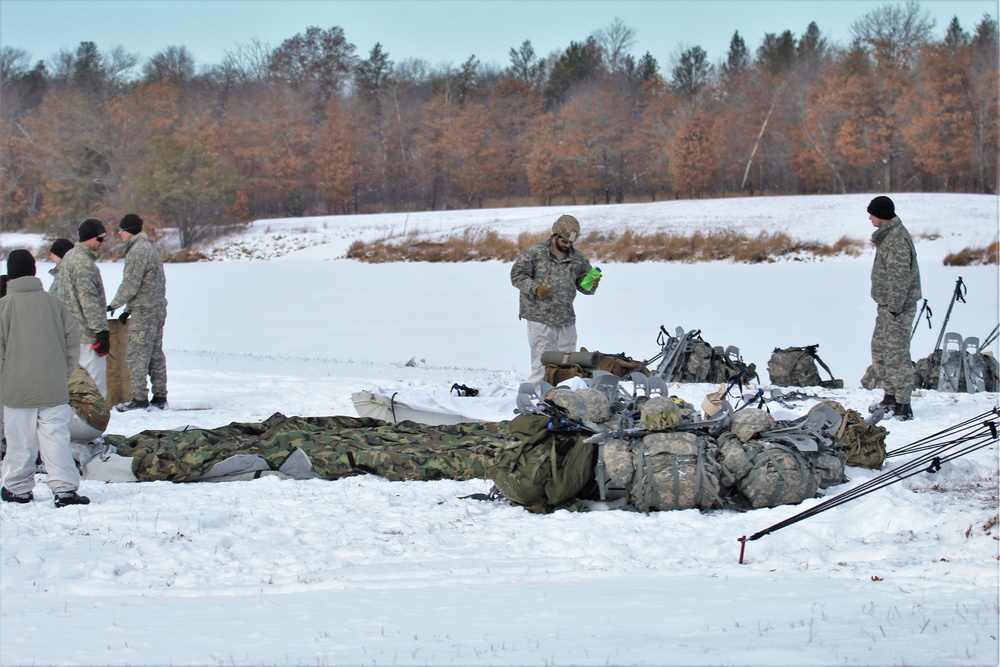 Cold-Weather Operations Course Class 18-02 students build Arctic tents during training at Fort McCoy