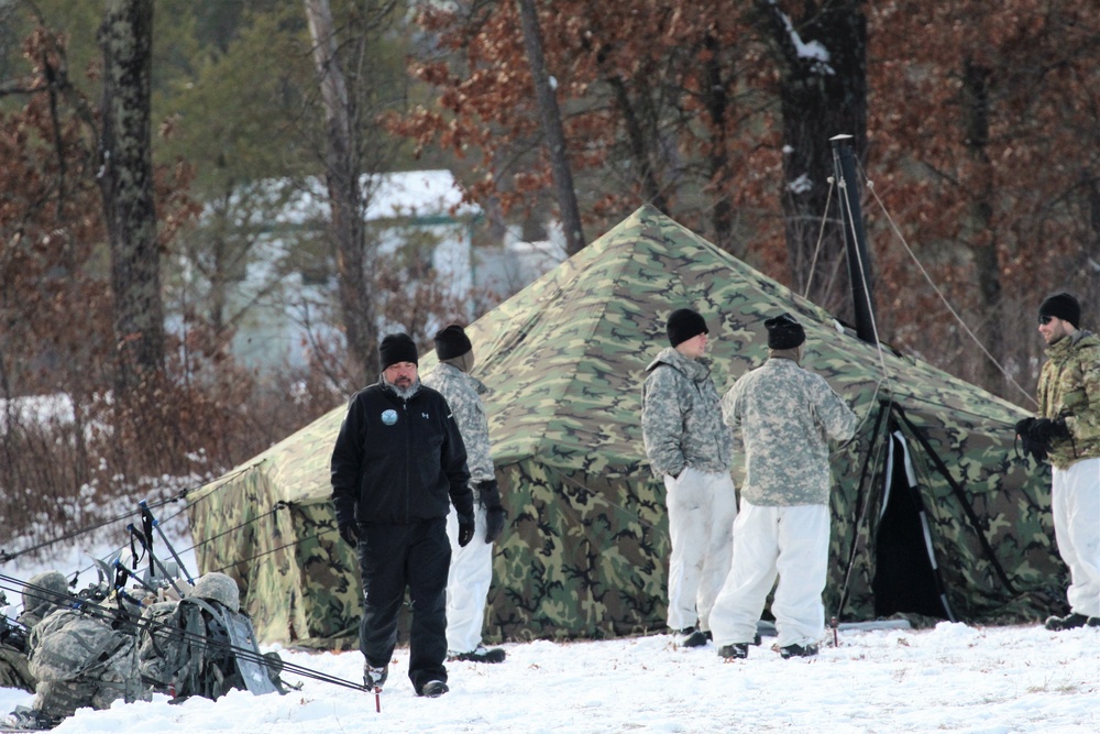 Cold-Weather Operations Course Class 18-02 students build Arctic tents during training at Fort McCoy
