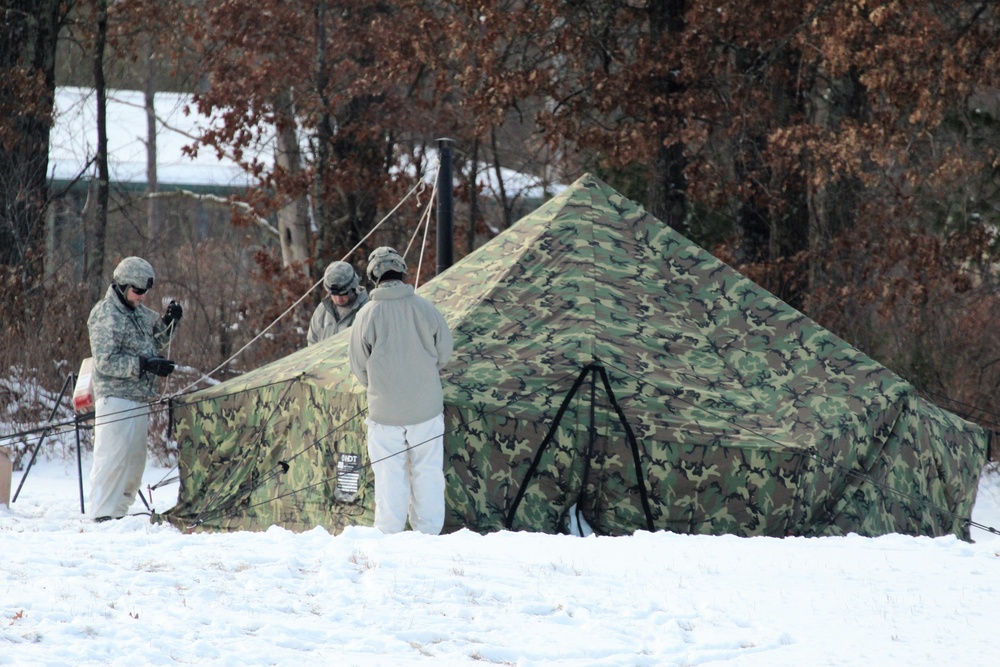 Cold-Weather Operations Course Class 18-02 students build Arctic tents during training at Fort McCoy