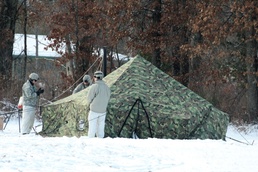 Cold-Weather Operations Course Class 18-02 students build Arctic tents during training at Fort McCoy