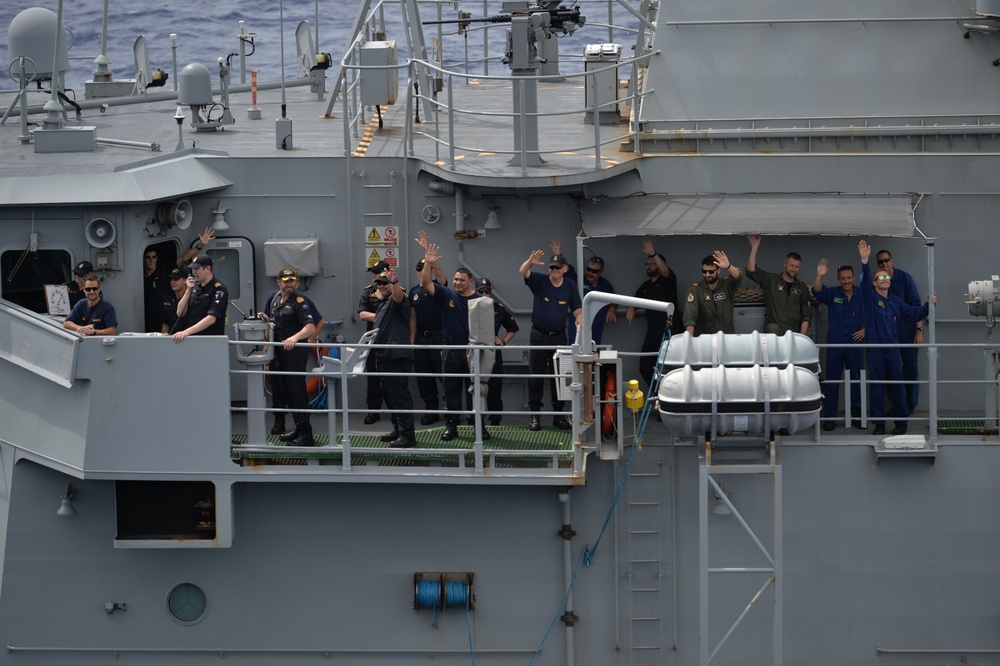 HMNZS Te Kaha (F77) Sailors Wave at USS Nimitz (CVN 68)