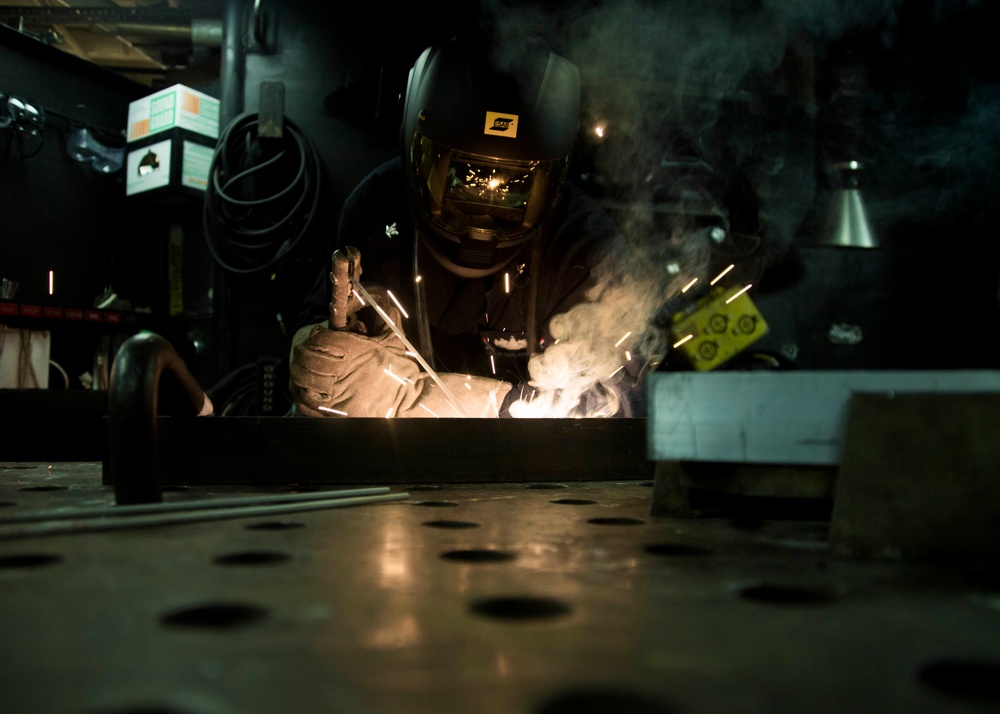 Sailor welds a bracket