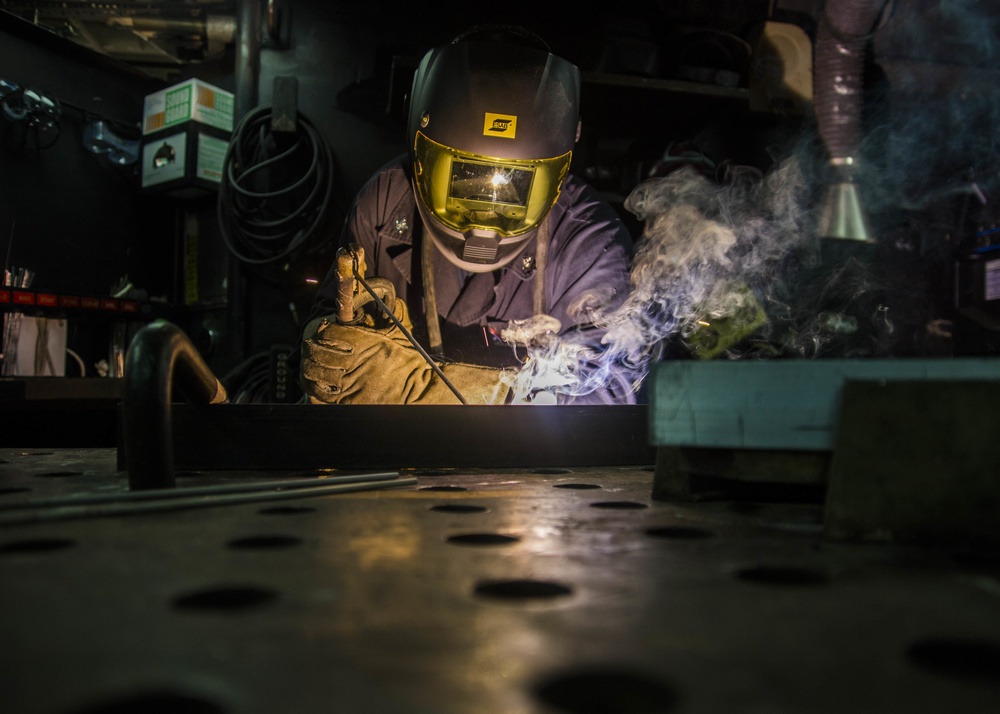 Sailor welds a bracket