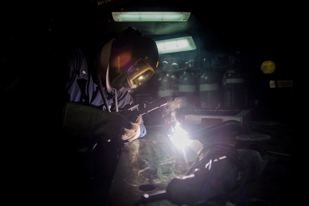 Sailor welds a bracket