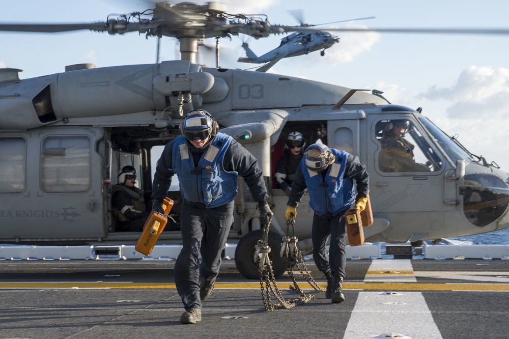 MH-60 Helicopters assigned to the &quot;Sea Knights&quot; of HSC 22 conduct flight operations aboard USS Bonhomme Richard (LHD 6)