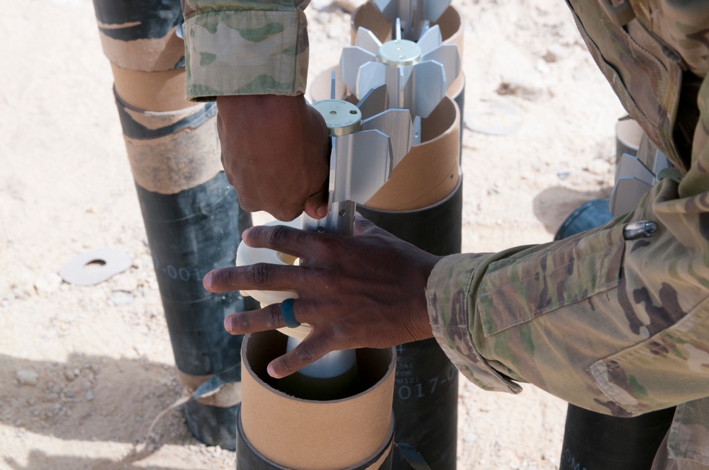 Mortarman prepares 120mm rounds during Inferno Creek 18