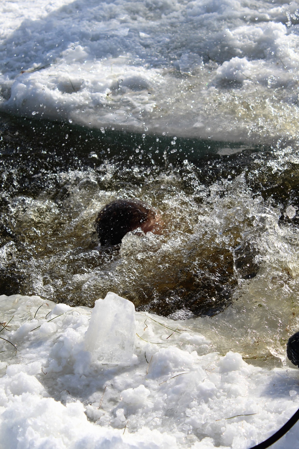 Students take plunge in icy water for Cold-Weather Operations Course 18-02 at Fort McCoy