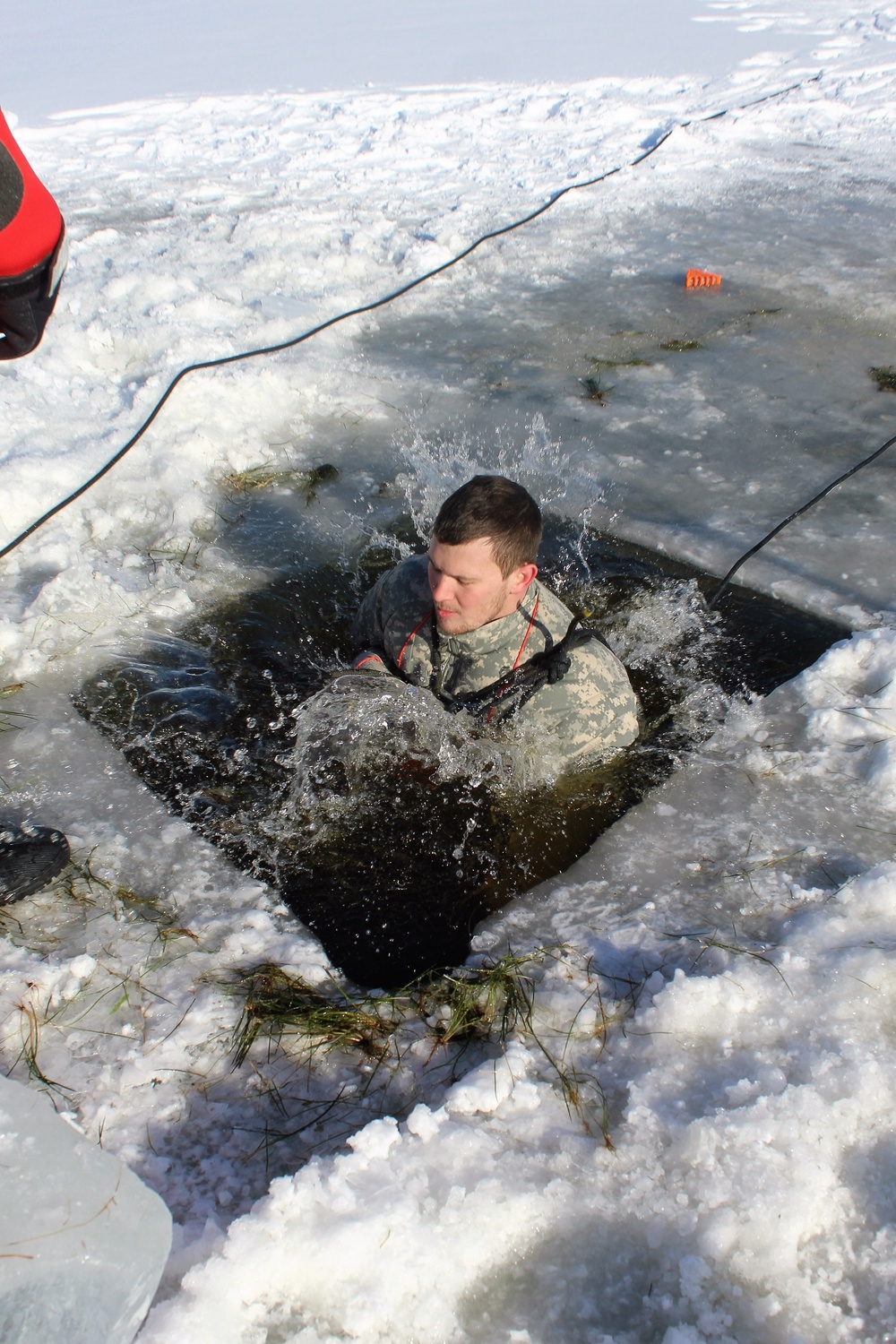 Students take plunge in icy water for Cold-Weather Operations Course 18-02 at Fort McCoy