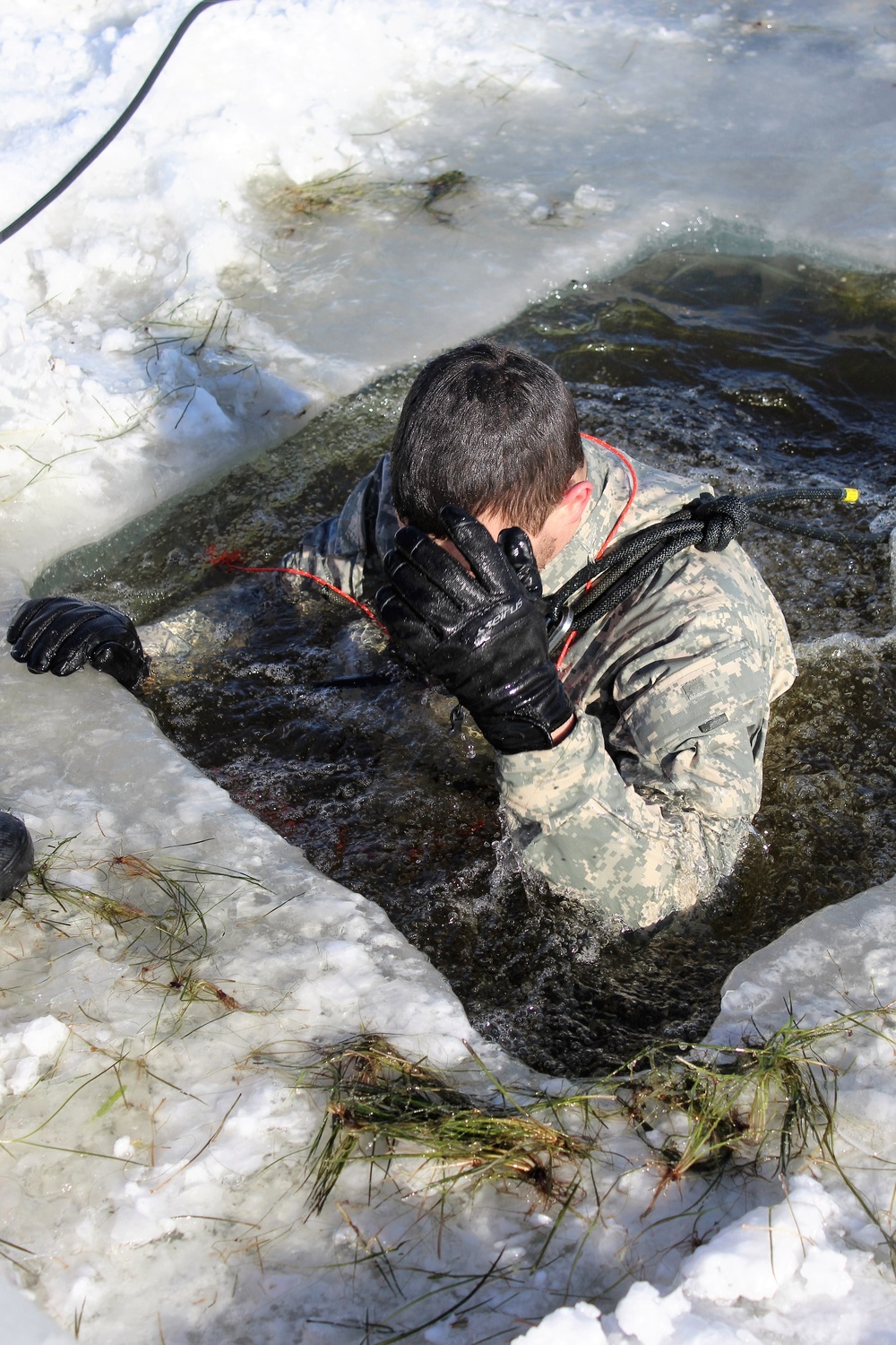 Students take plunge in icy water for Cold-Weather Operations Course 18-02 at Fort McCoy