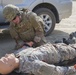 Soldier applies tourniquet to training mannequin