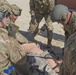 Soldiers assess simulated casualty for training