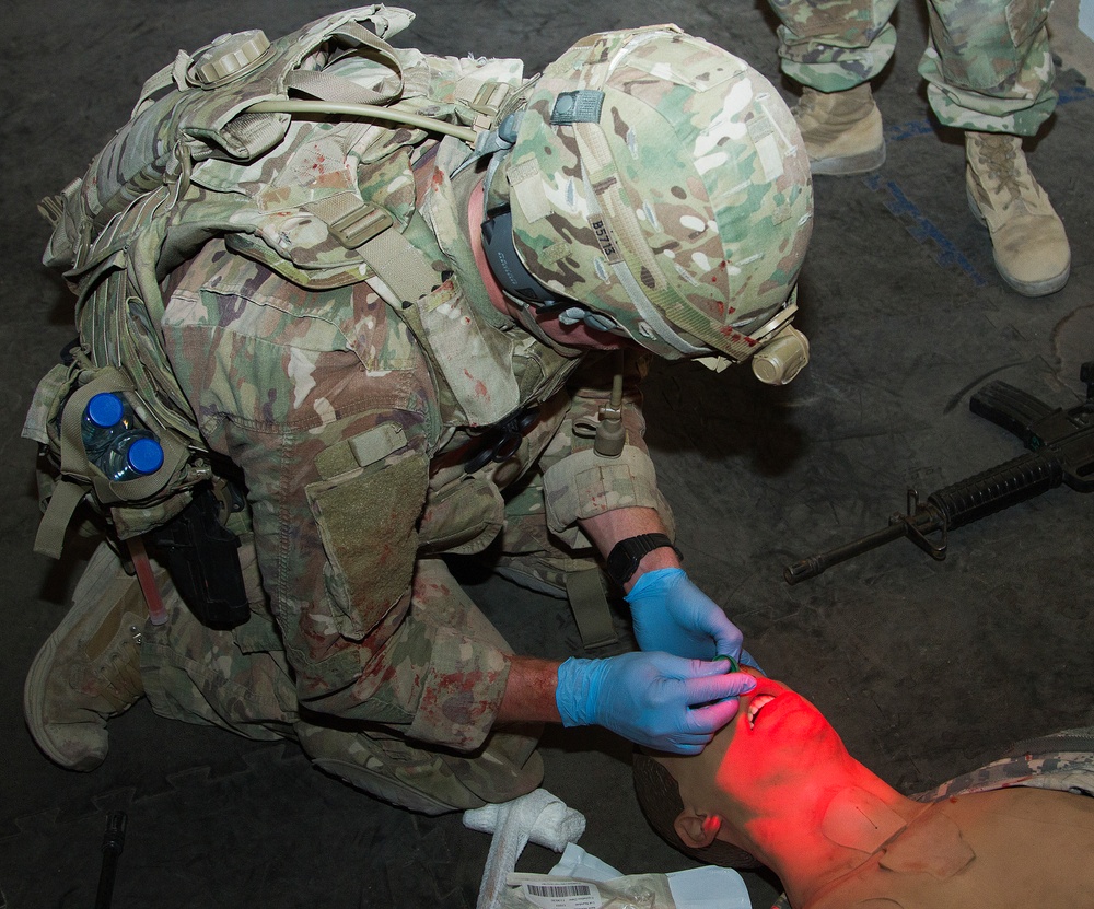 Soldier treats simulated casualty for training