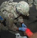 Soldier treats simulated casualty for training