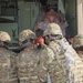 Soldiers load simulated casualty into ambulance