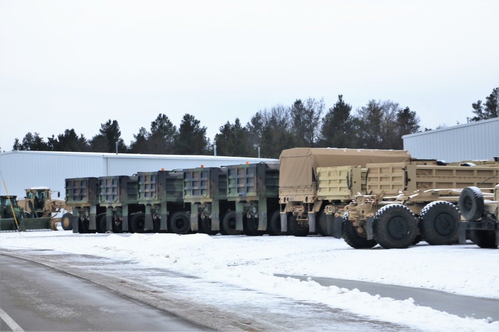 Military vehicles staged for rail movement from Fort McCoy