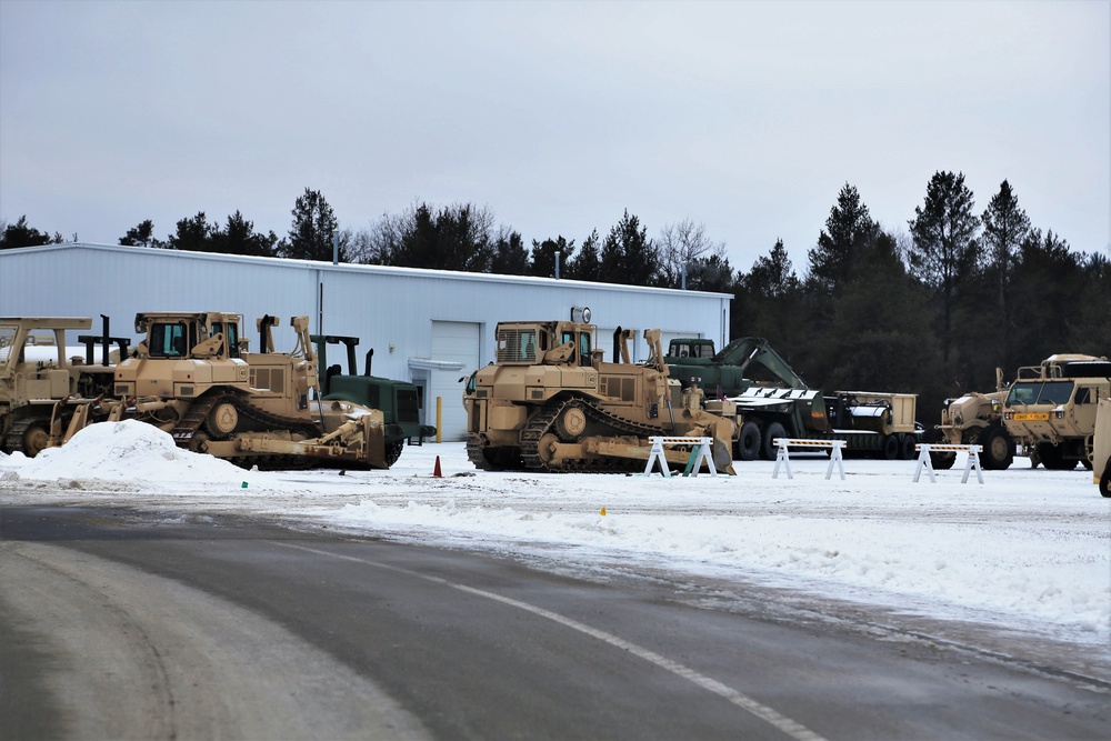 Military vehicles staged for rail movement from Fort McCoy