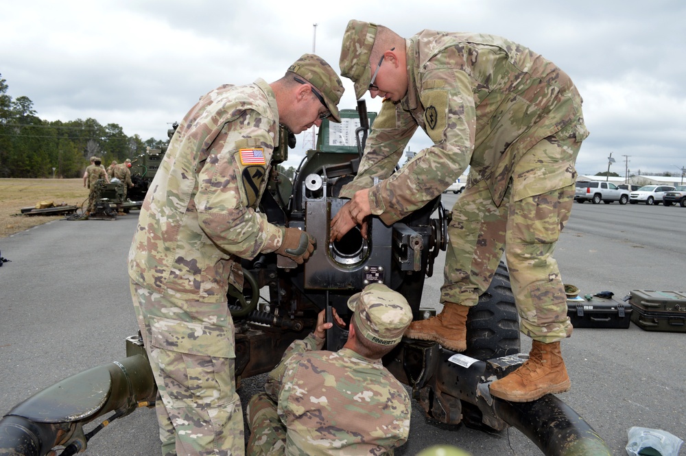 Cannon crewmembers prep howitzer for JRTC